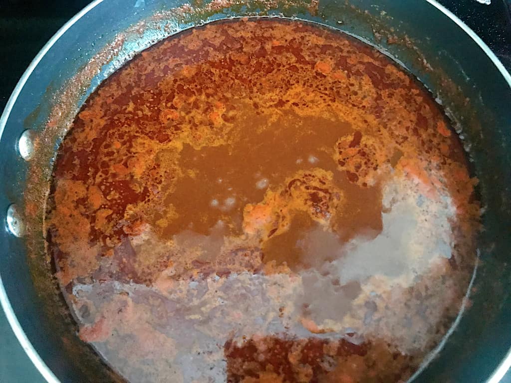 Bring enchilada sauce to a boil, then reduce the heat and simmer for 30-45 minutes, stirring occasionally.