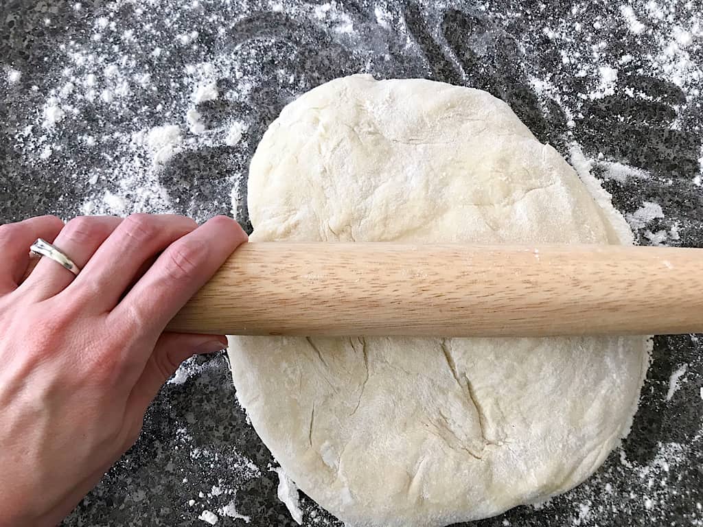Punch down the dough and pour it out onto a floured surface and use a rolling pin to roll out a rectangle about 18 x 9 inches.