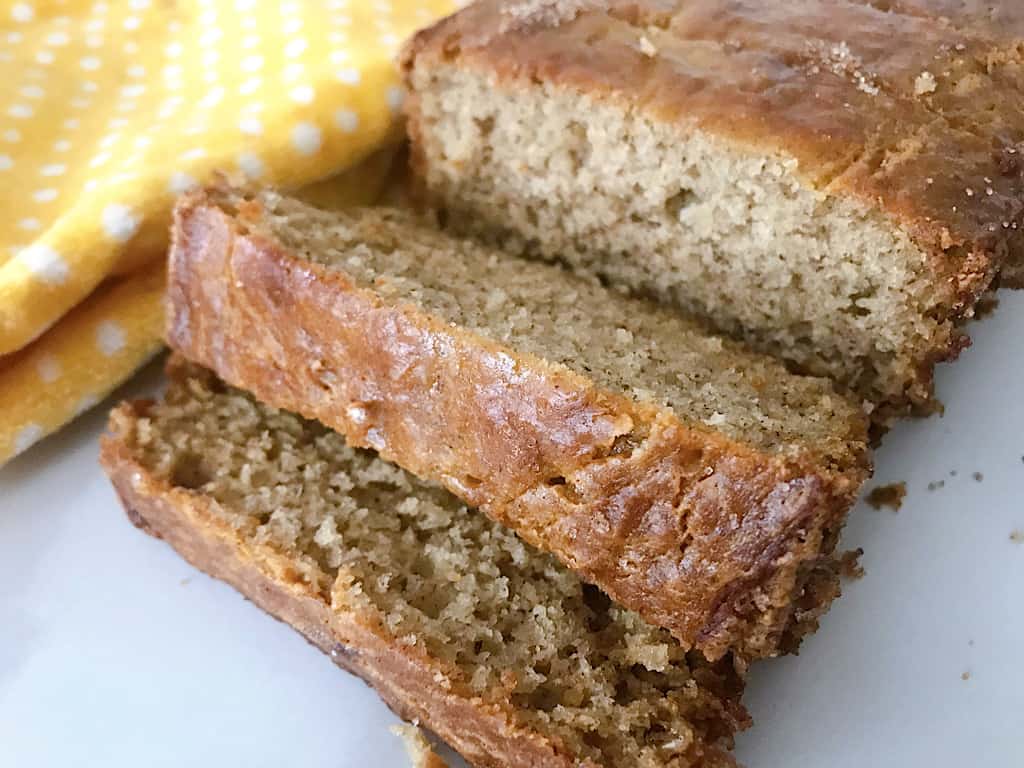 A loaf of sour cream banana bread cut into slices