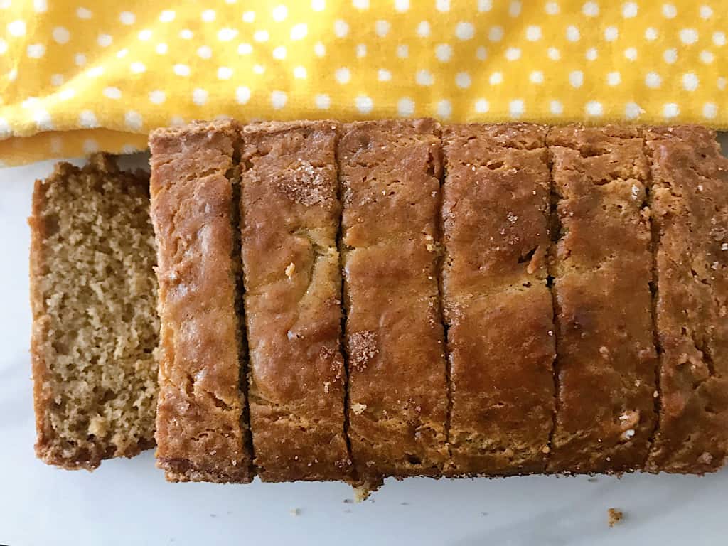 Sliced Banana Bread and a yellow kitchen towel