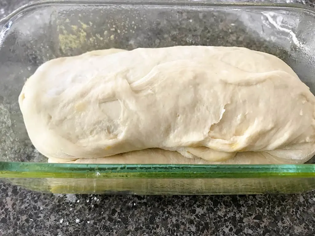 Fold the ends of the dough under the center of the roll and place in a greased 9 x 5 x 3 loaf pan.