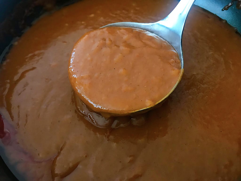 Cover the bottom of a 9x13 baking dish with enchilada sauce.