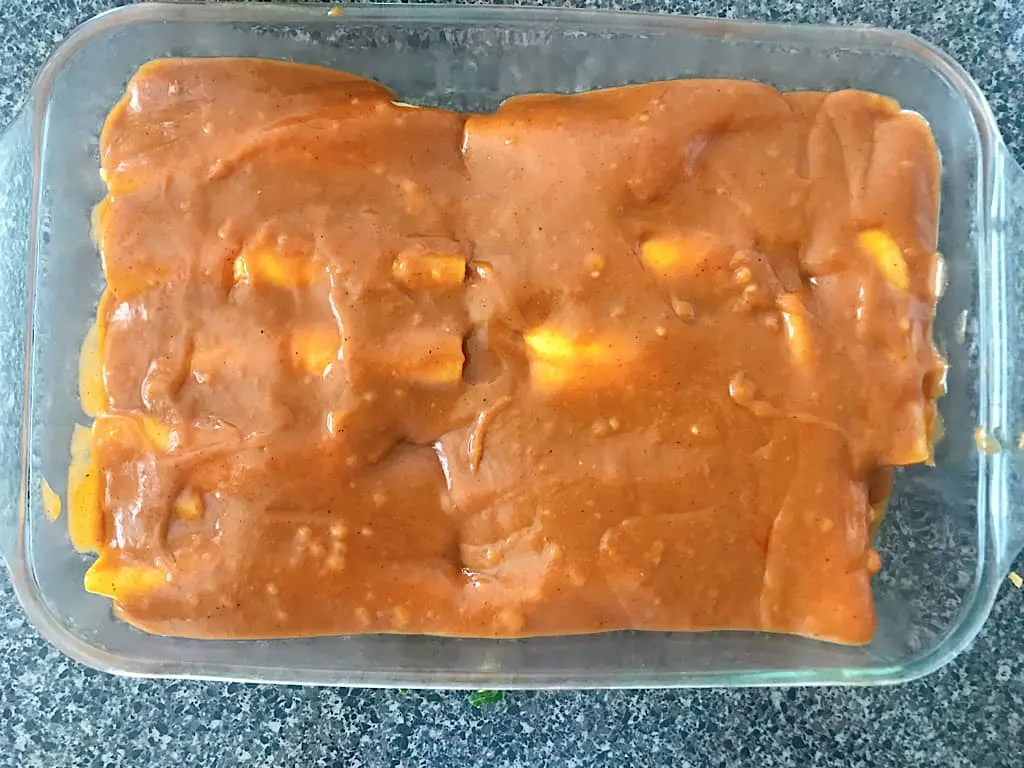Cover the enchiladas with sauce and top with the remaining shredded cheese.