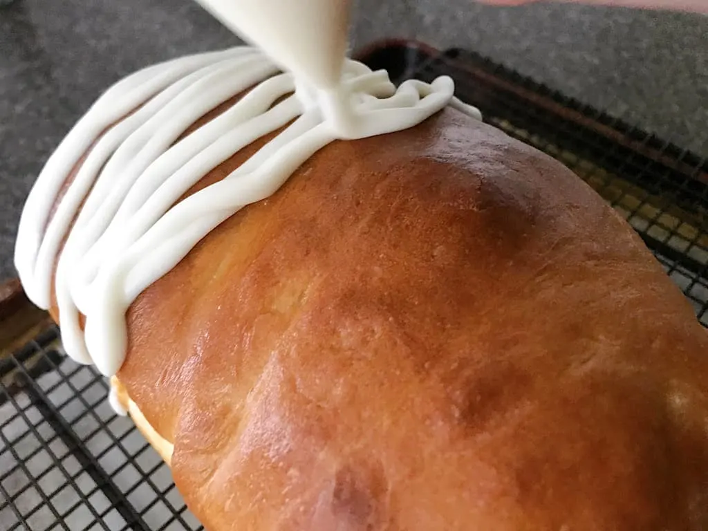 Glaze: Whisk together the powdered sugar and cream. Drizzle over the top of the bread.