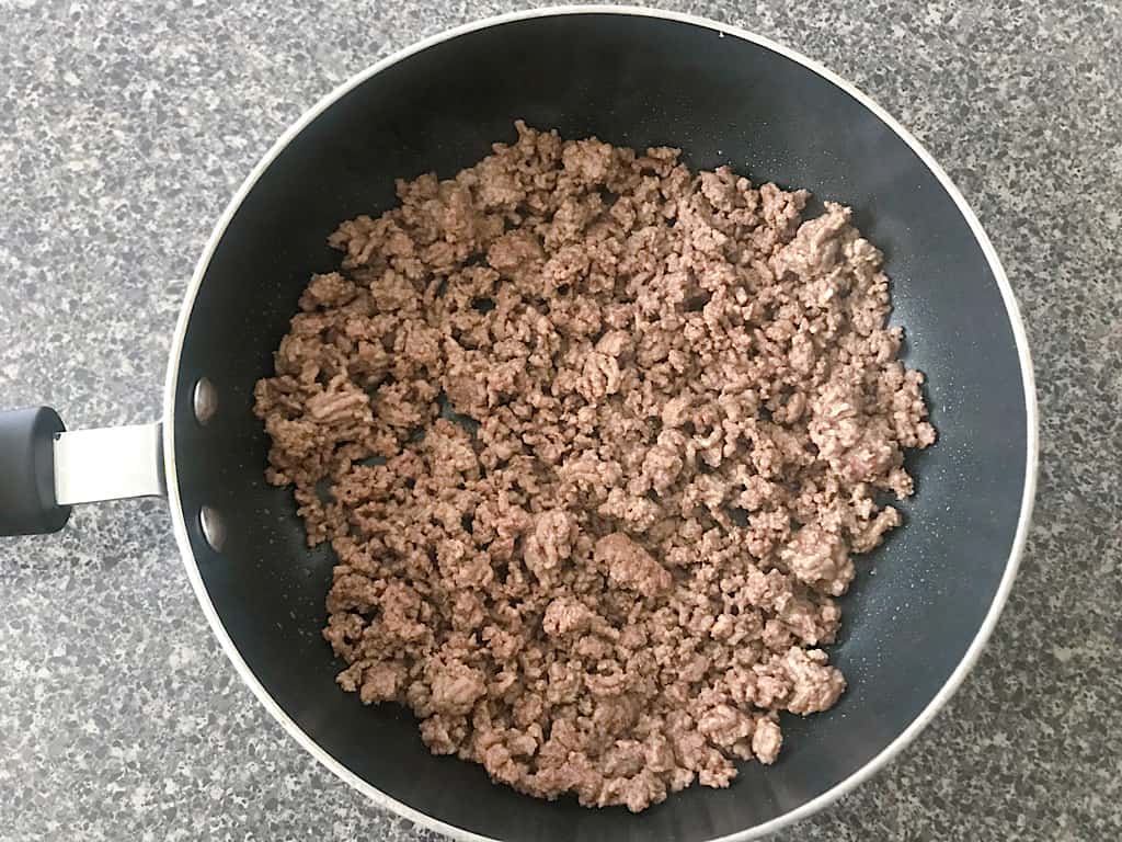 Place the ground beef to a large pan and cook over medium-high heat until no longer pink.