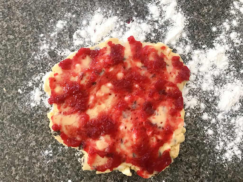 Use a butter knife to spread the preserves over the dough. 