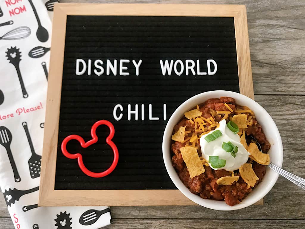 A letter board that says Disney World Chili and a bowl of chli
