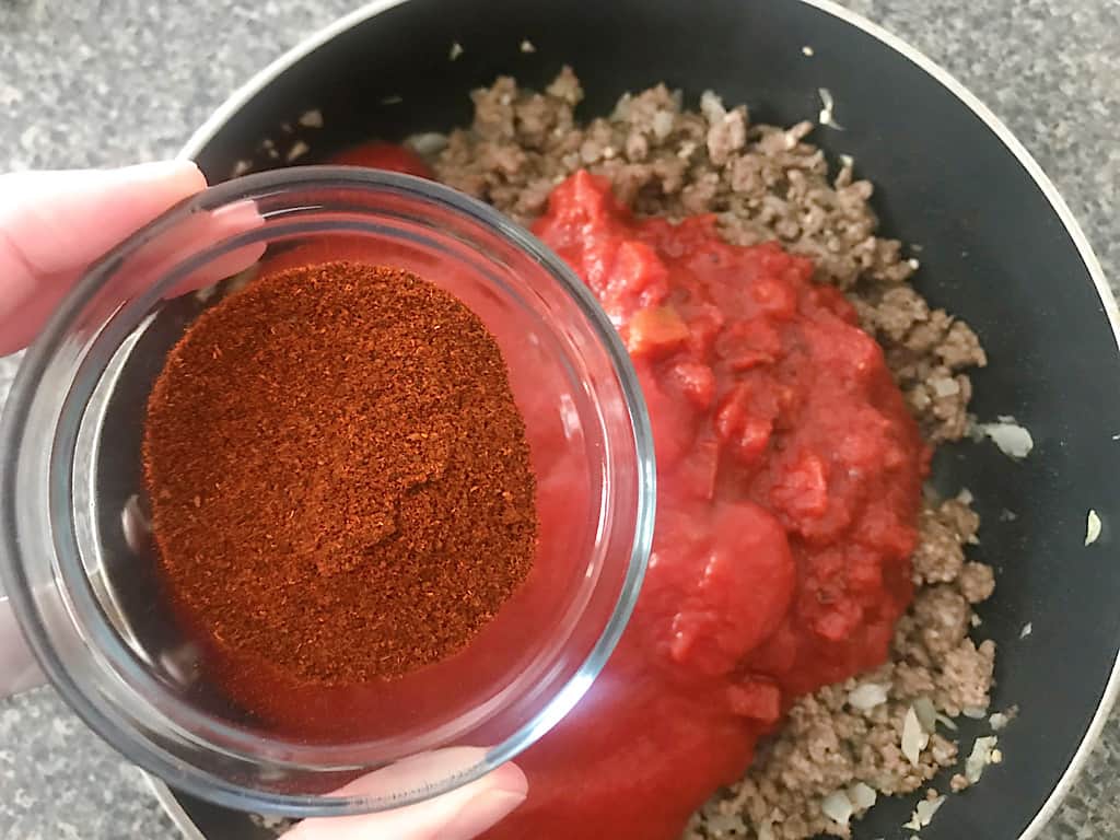 Add the chili powder, cumin, salt, pepper, and cayenne pepper.