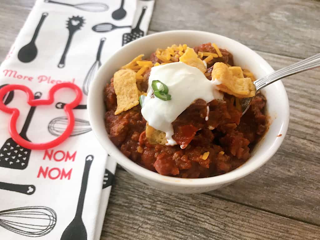 A bowl of chili and a Mickey Mouse Towel