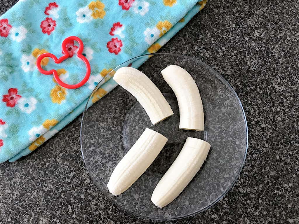 Peel and cut the bananas in half.