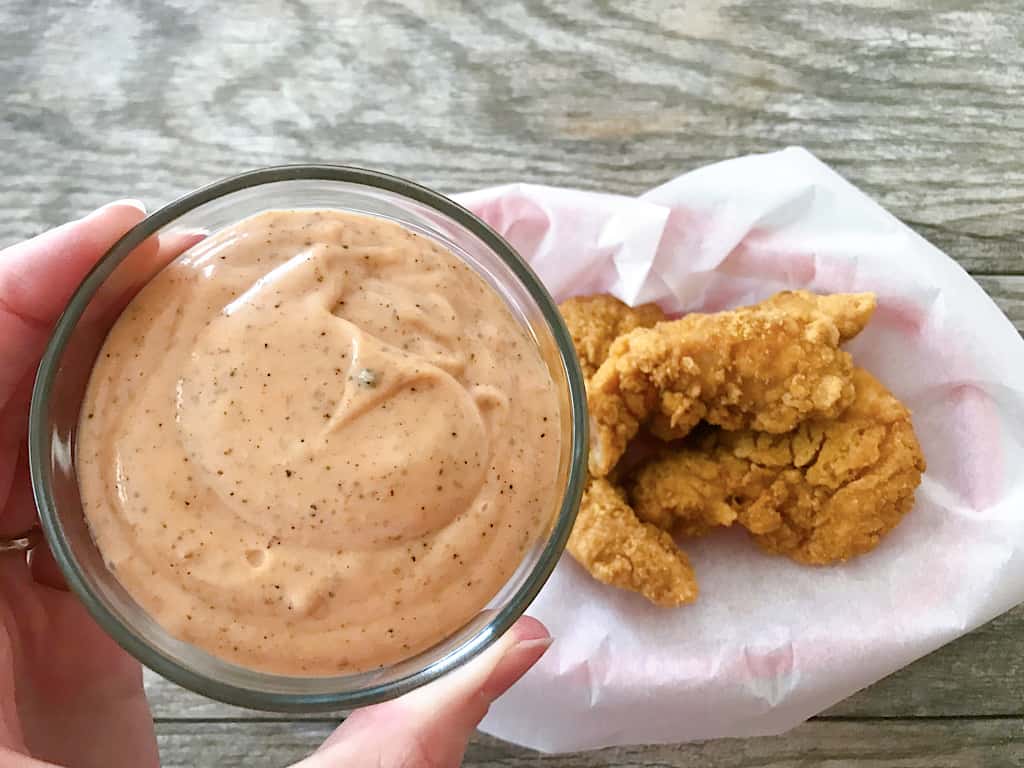 A bowl of Copycat Raising Cane's Sauce and chicken strips