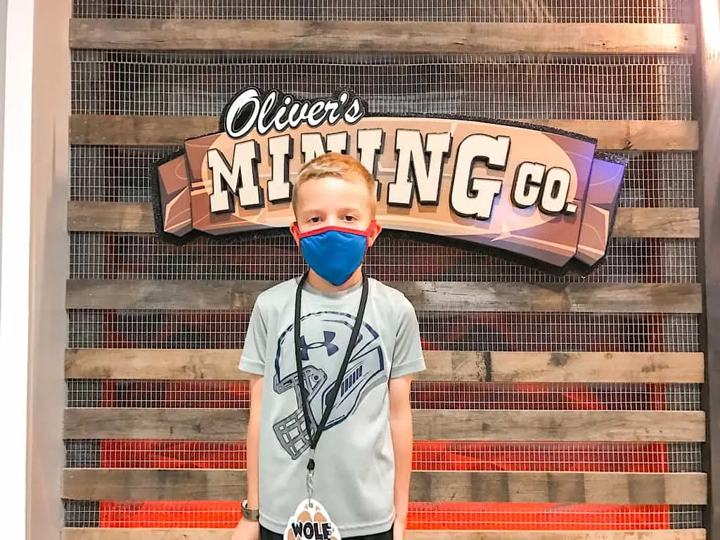 A boy standing in front of Oliver's Mining Co at Great Wolf Lodge Grand Mound, Washington