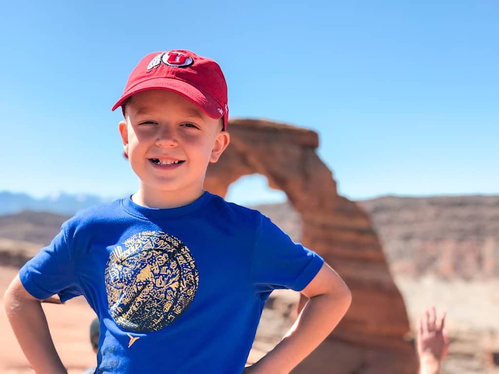 A child at Delicate Arch in Arches National Park