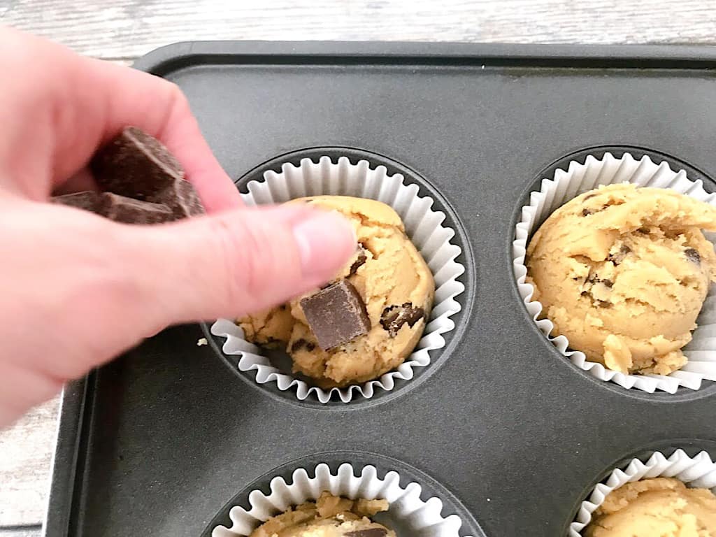 Use a 1/4 Cup Cookie Scoop to scoop the dough into each liner. Press 3 or 4 chocolate chunks on top of each cookie.