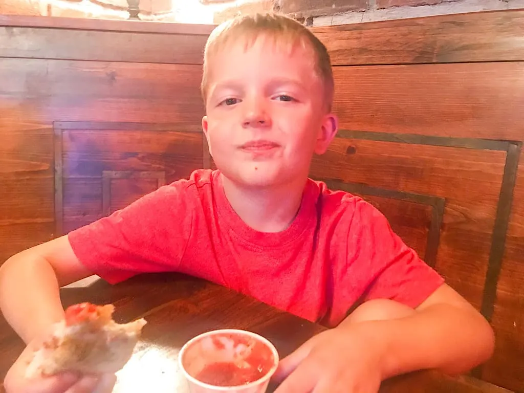 A boy eating pizza at Pinky G's Pizzeria in Jackson Hole, Wyoming