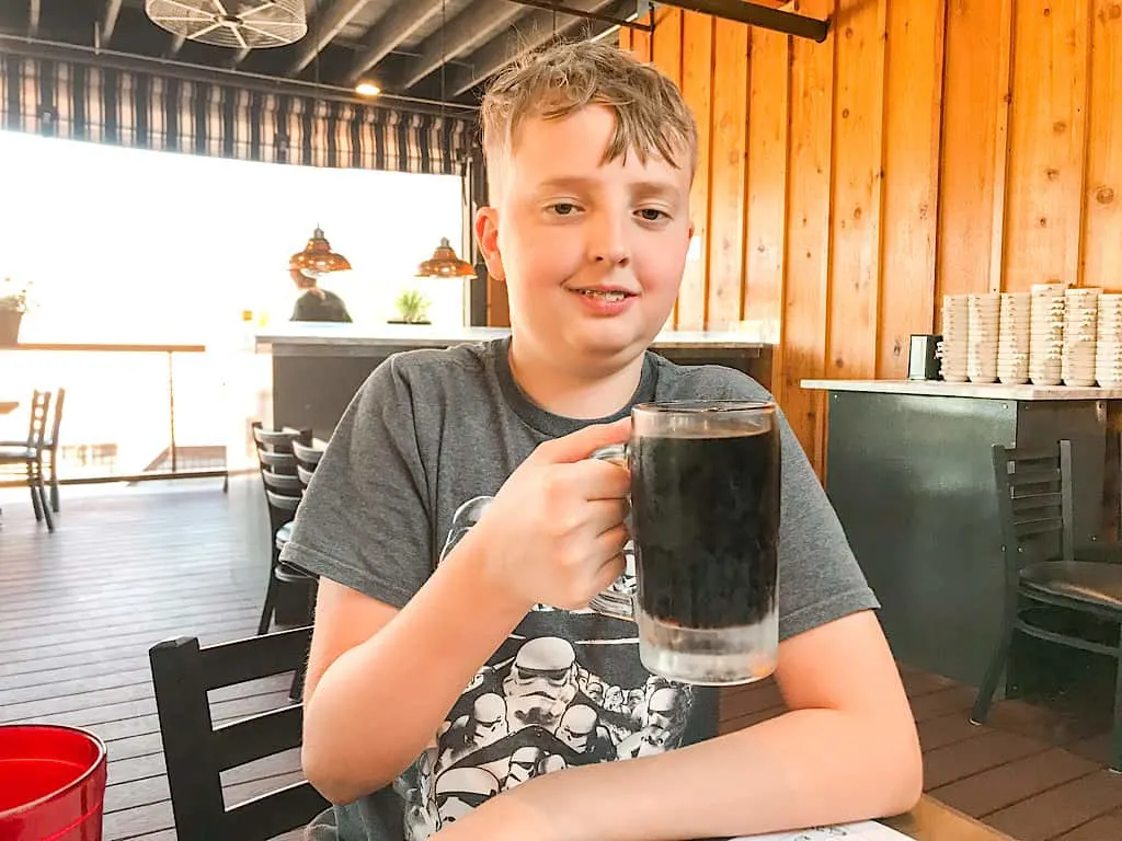 A boy with a mug of root beer at Zax Restaurant in Moab, Utah