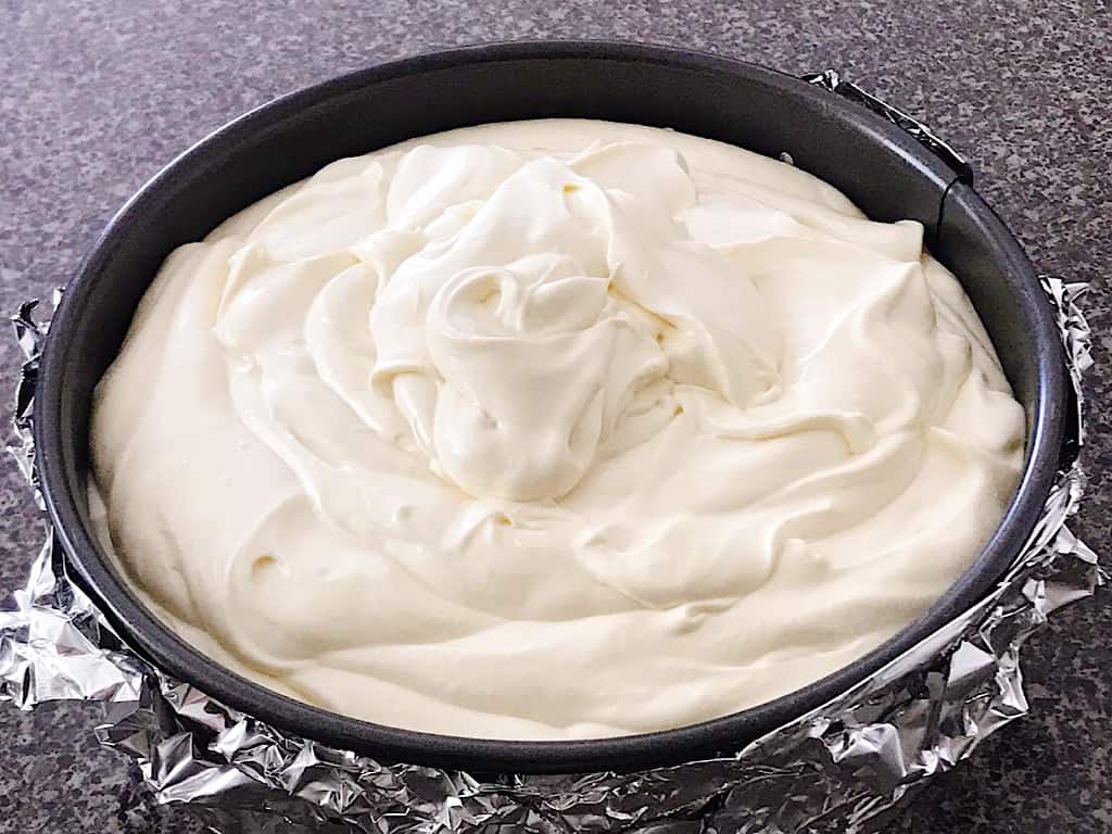 Cheesecake batter in a springform pan.