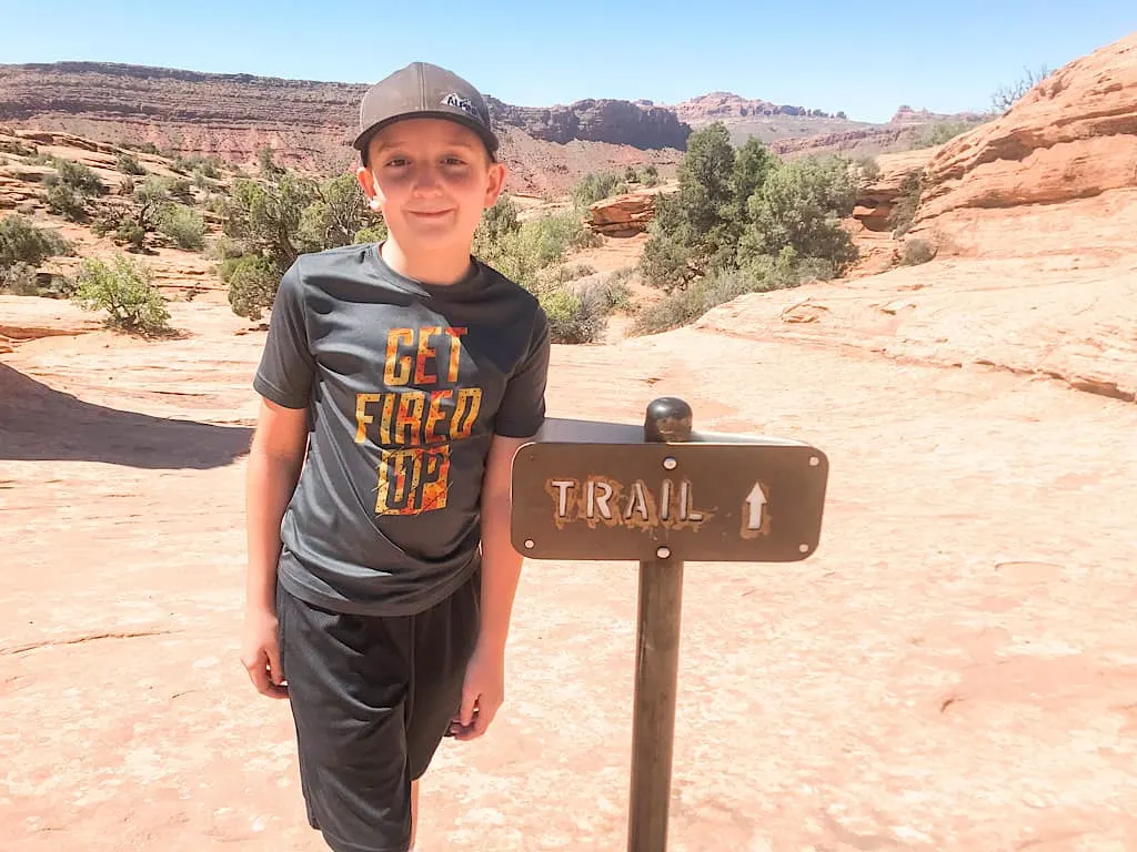 A boy on the trail to Delicate Arch at Arches National Park