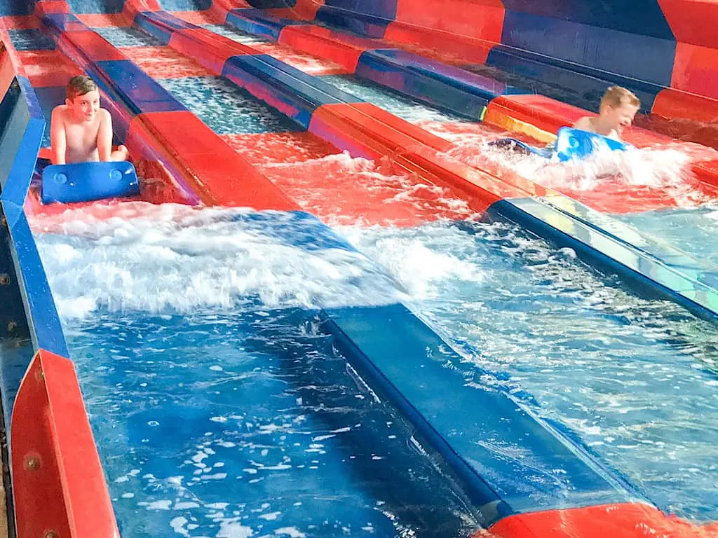 kids coming down racing water slides at Great Wolf Lodge Southern California