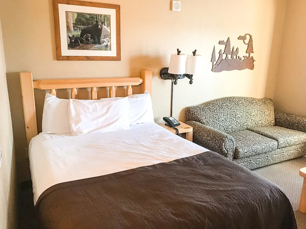 Queen bed and sofa sleeper in Wolf Den Suite