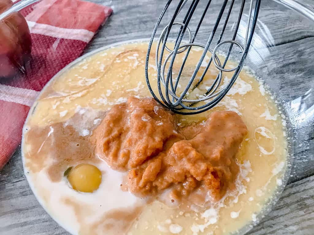 In a separate bowl, whisk together the eggs, brown sugar, pumpkin puree, milk, melted butter, and vanilla extract.