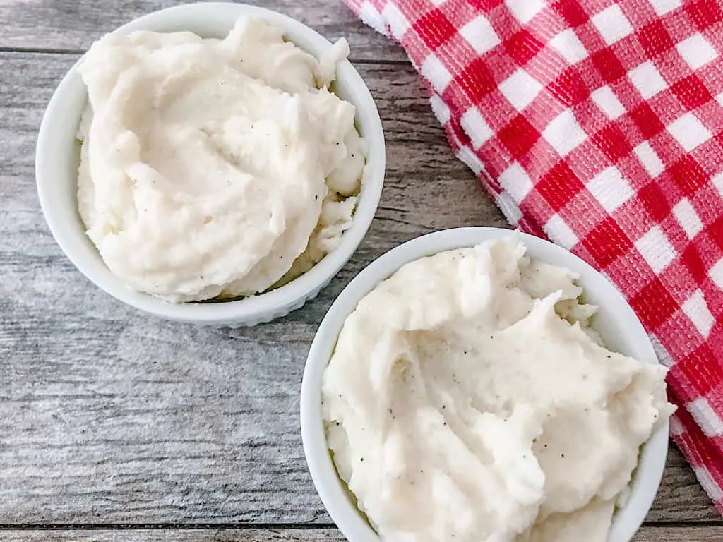 Two bowls of mashed potatoes.