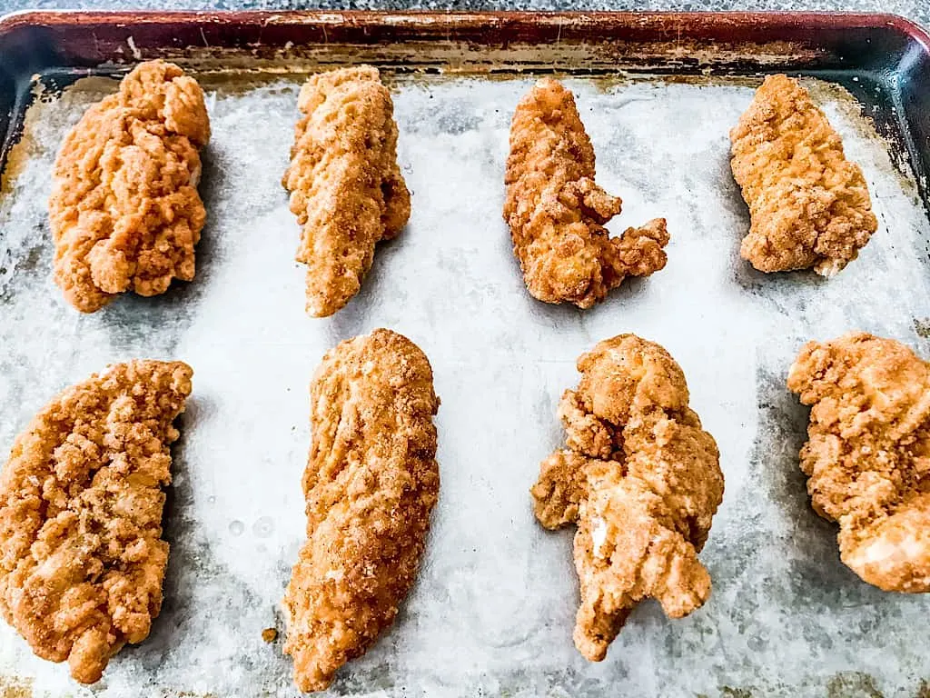 Heat the frozen chicken tenders according to package directions or prepare 1 recipe of Oven Fried Chicken Tenders.