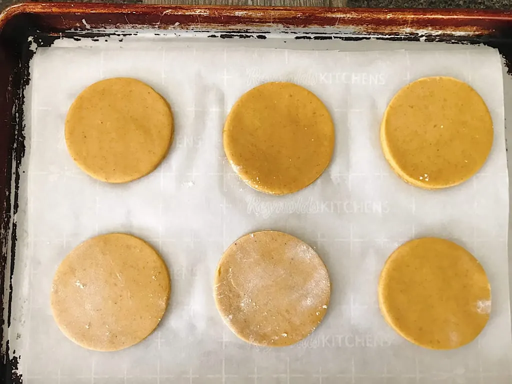 Sugar Cookie dough cut outs on a baking sheet
