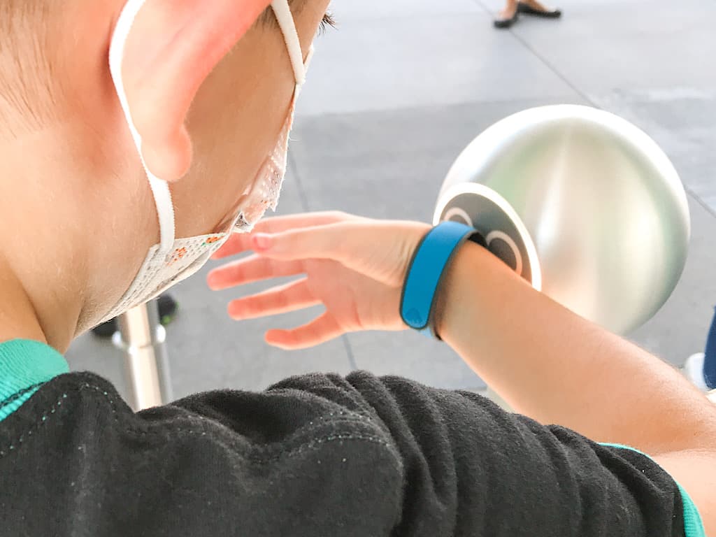 A boy scanning a Magic Band at Disney World