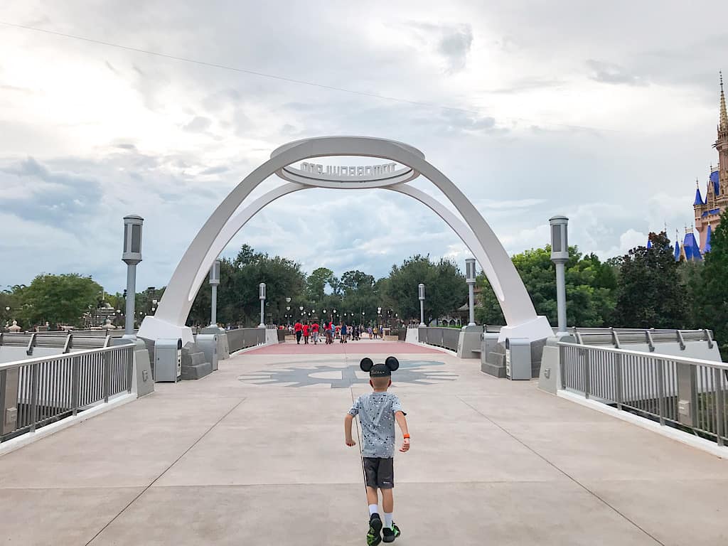 A child with Mickey Ears near the entrance of Tomorrowland at Disney's Magic Kingdom Park