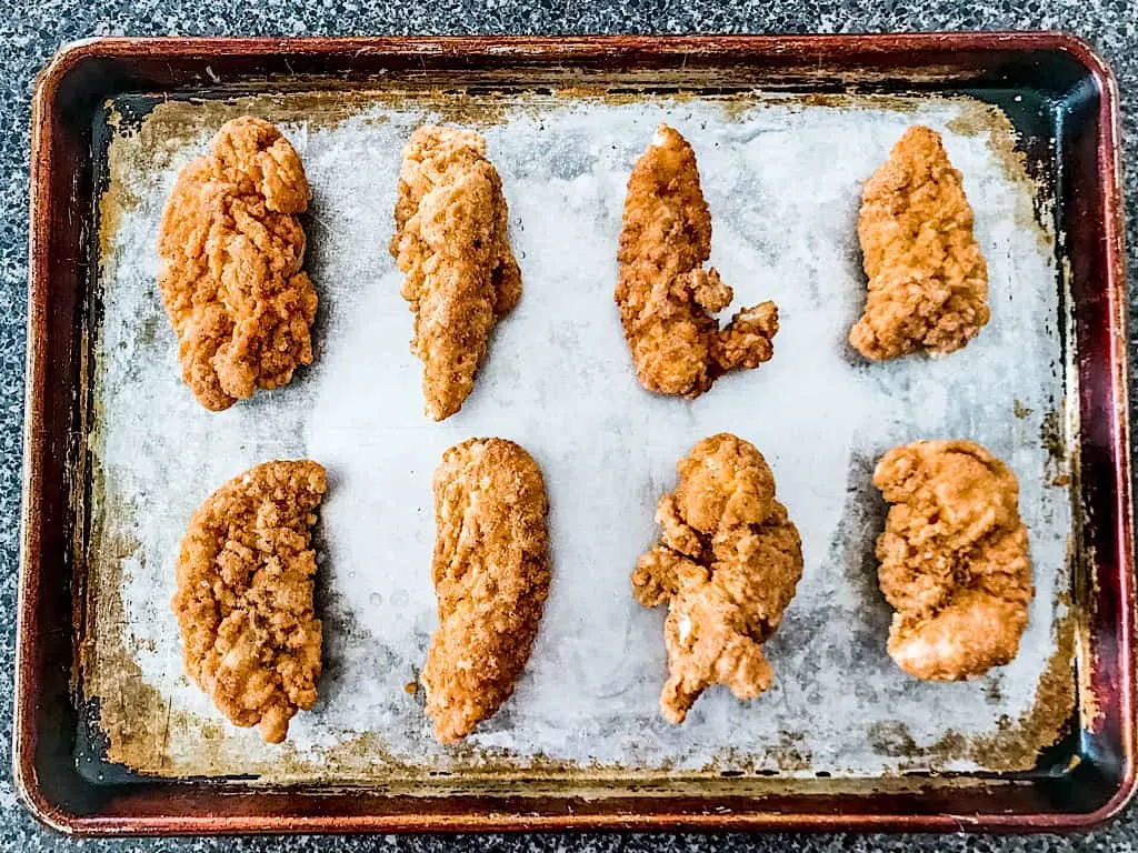 Chicken tenders on a baking sheet