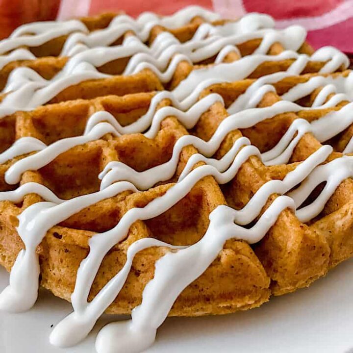 A Pumpkin spice waffle drizzled with cream cheese syrup