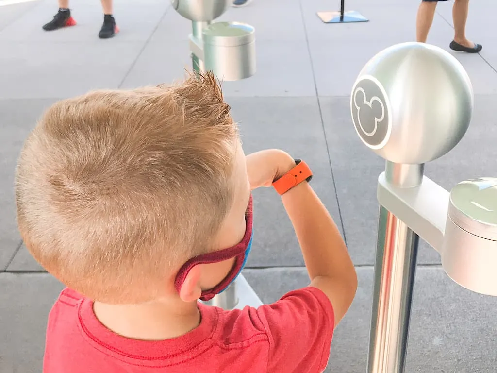 A boy scanning a magic band at Disney World