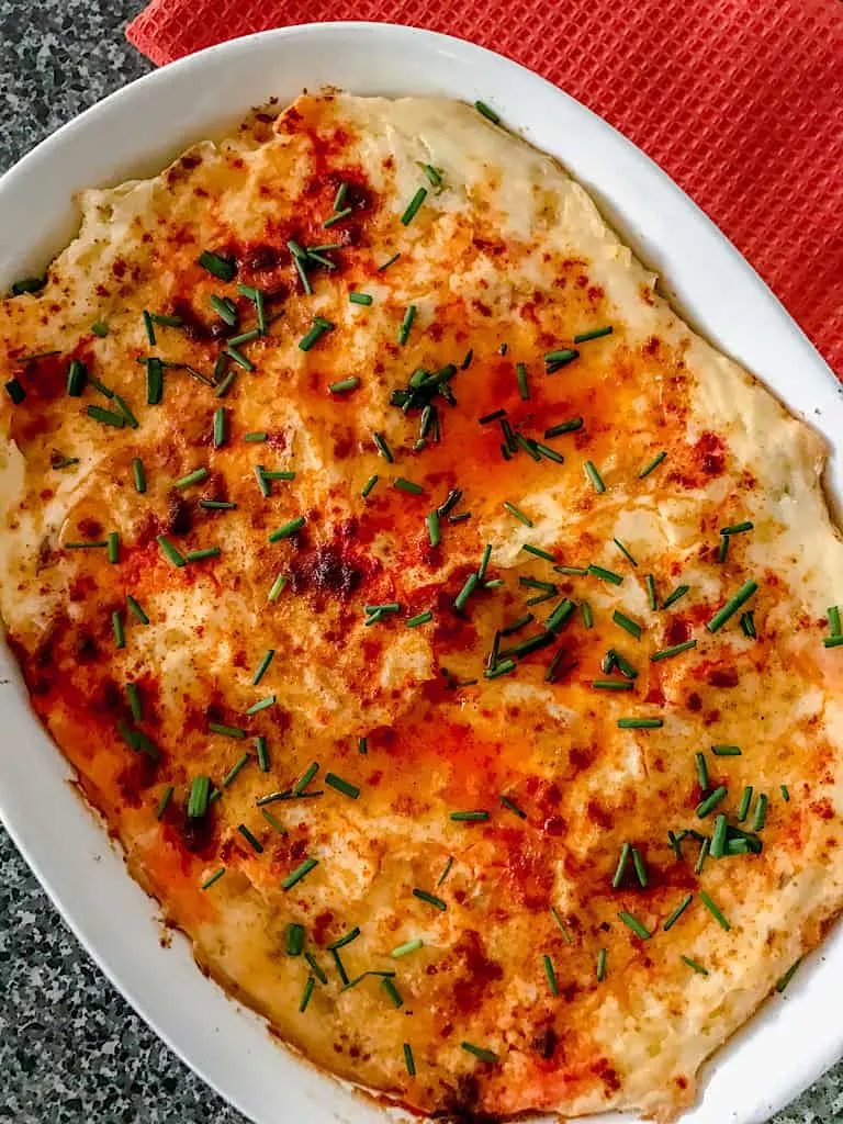 A pan of make ahead mashed potatoes perfect for Thanksgiving.