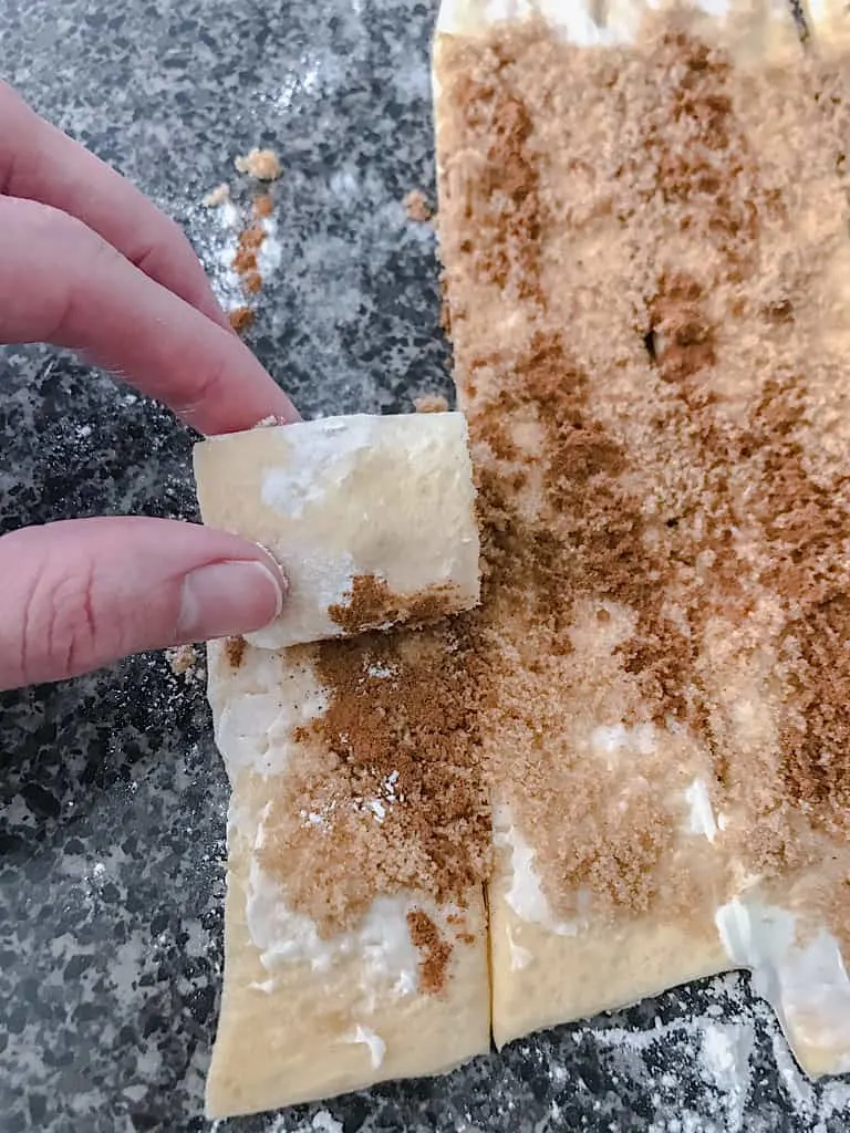 For each Mickey ear, roll up one strip of cinnamon covered dough. For Mickey's head, connect two strips of dough to make one large roll.