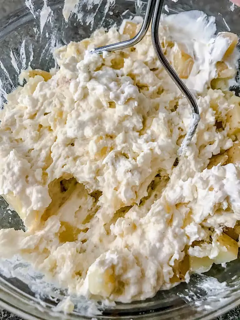 Use a potato masher to smash the potatoes and mix in the other ingredients.