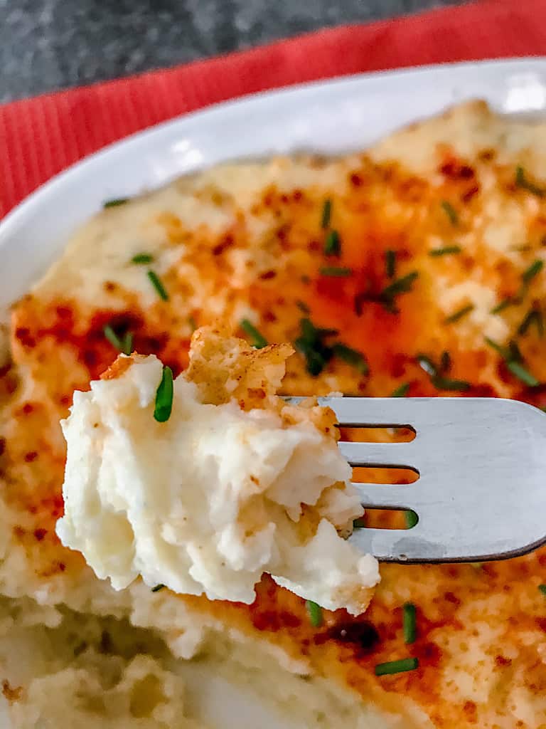 A fork with make ahead mashed potatoes