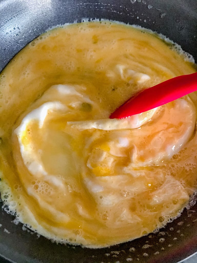 Wait again for about a minute until those eggs begin to solidify, and run the spatula through the eggs again to allow the liquid to touch the pan.