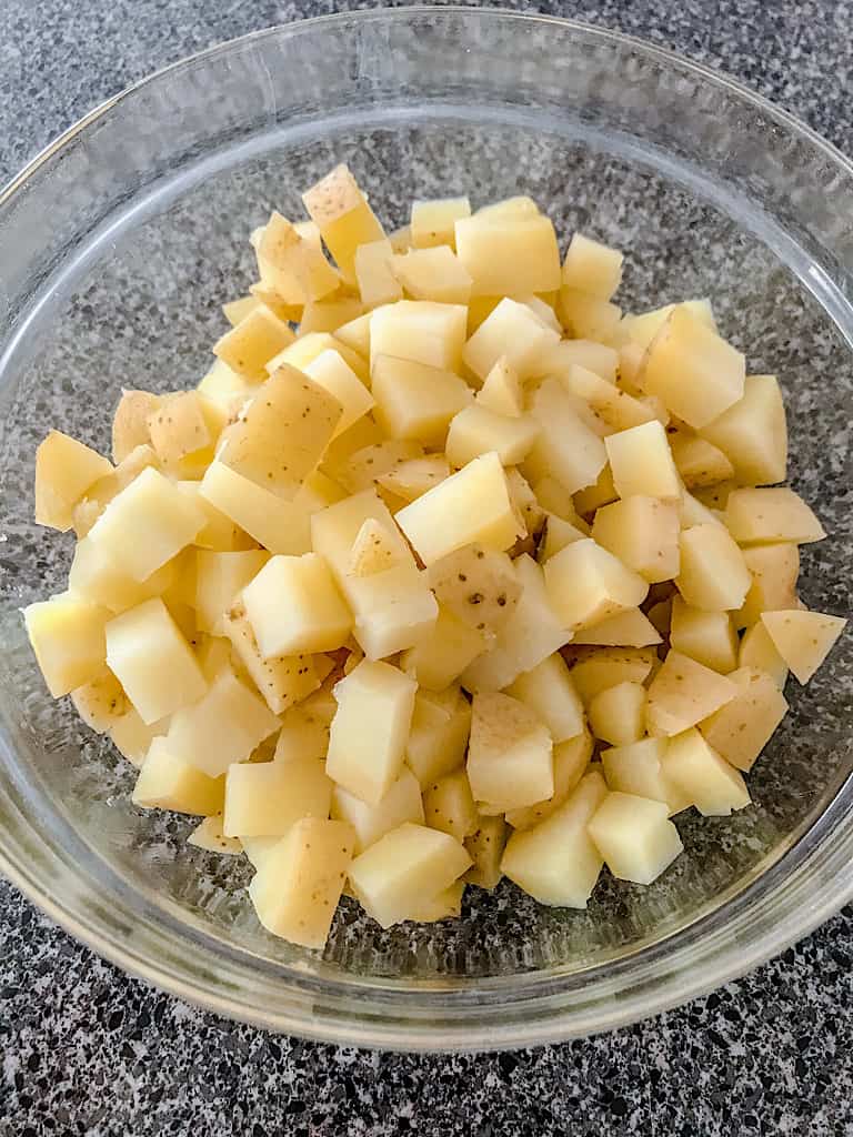 Drain water and transfer potatoes to a bowl.