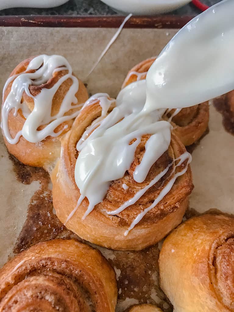 Drizzle the glaze over the freshly baked cinnamon rolls.
