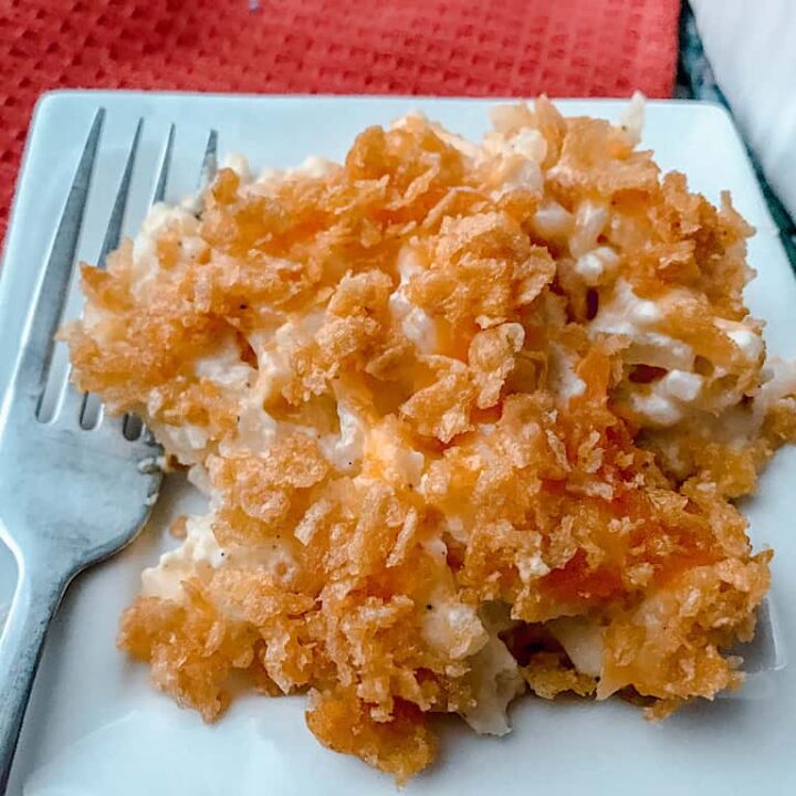 A plate of Funeral Potatoes Casserole and a fork.