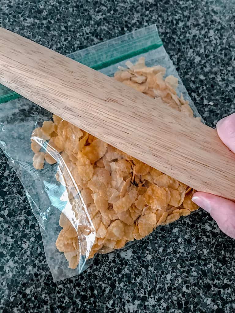Place the cornflakes in a ziplock bag and use a rolling pin to roughly crush.