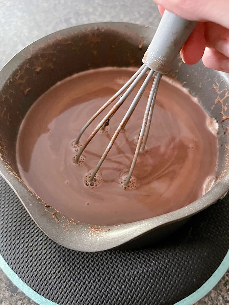 Remove the hot cocoa from heat and stir in the vanilla and heavy cream.
