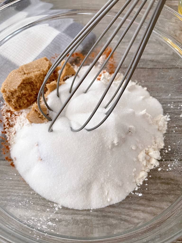 Whisk together the flour, baking powder, salt, brown sugar, sugar, and cinnamon in a large mixing bowl.
