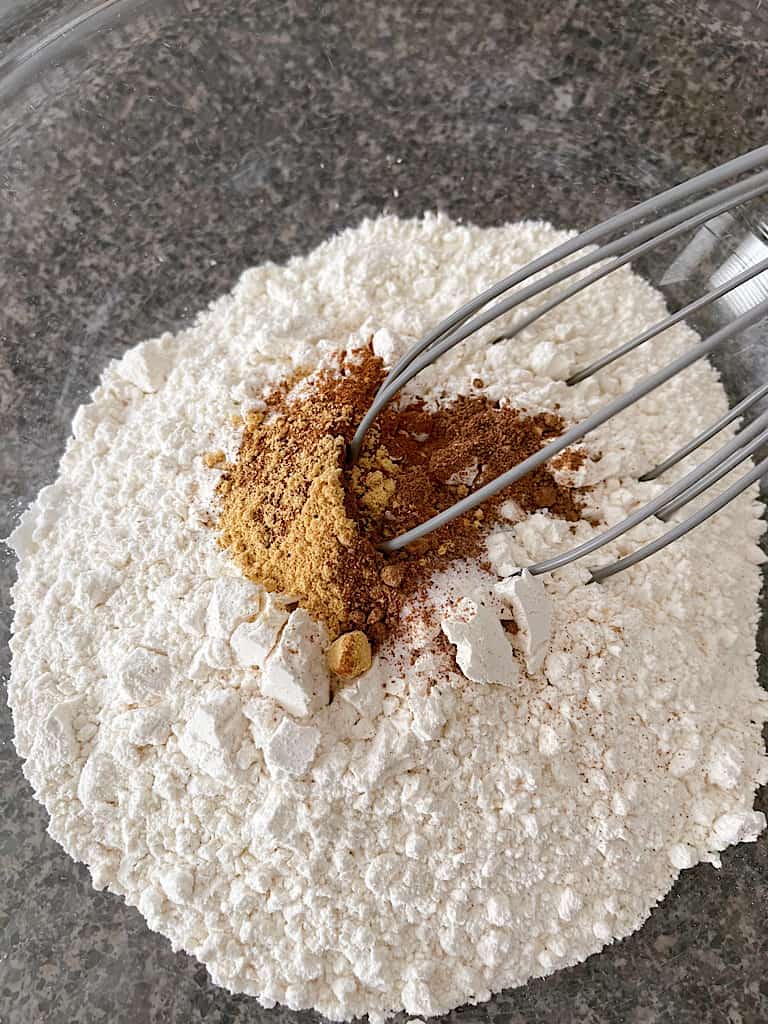 In a separate bowl, whisk or sift together the flour, baking powder, salt, and spices.