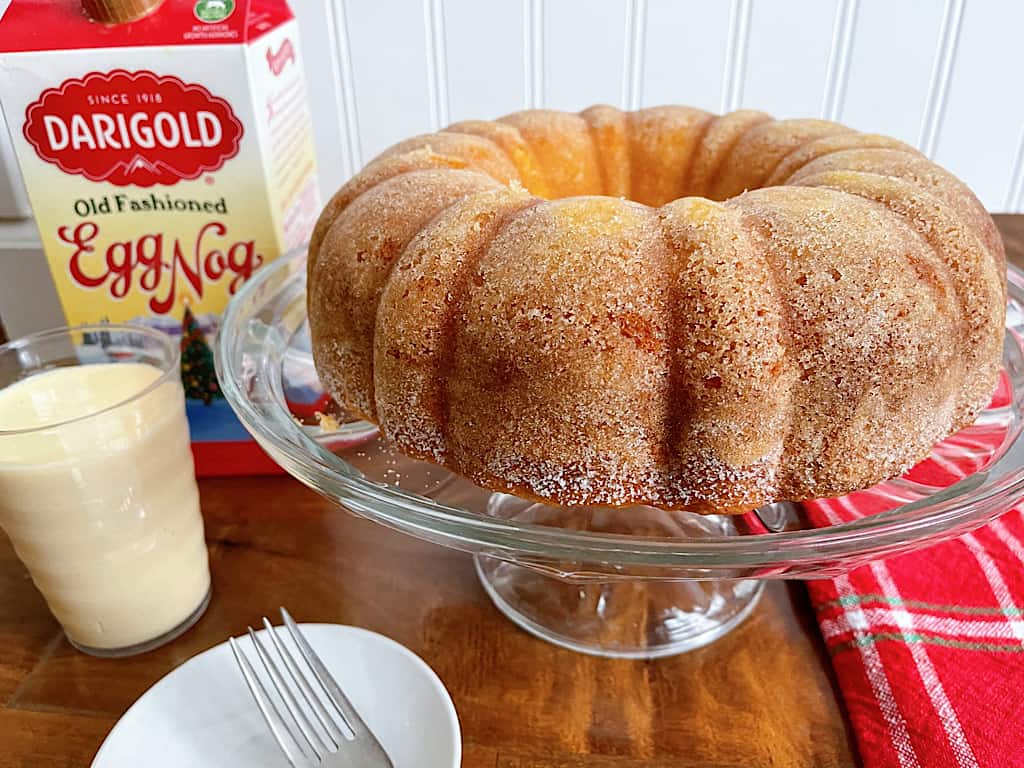 Eggnog bundt cake and a glass of eggnog.