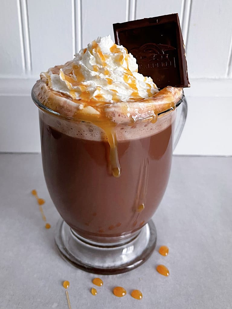 A mug of Ghirardelli Sea Salt Caramel Hot Cocoa