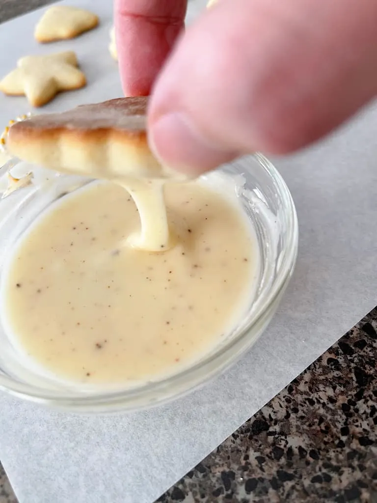 Dip each cookie in the icing, one at a time and allow excess to run off.