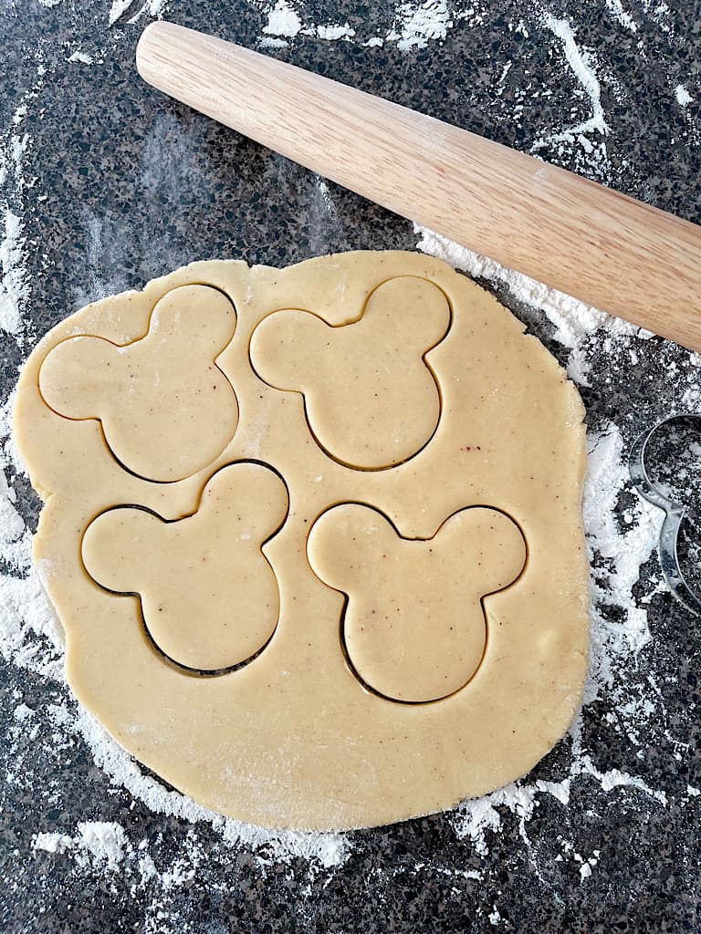 On a floured work surface, use a rolling pin to roll out the eggnog cookie dough until it is about 1/4-1/2 inch thick.