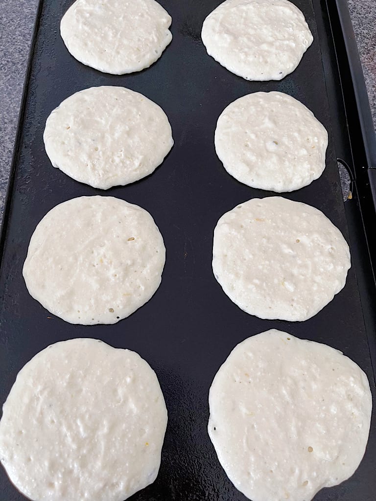 Heat a griddle to between 325 degrees and 350 degrees. Scoop approximately 1/4 cup batter for each pancake onto the griddle.